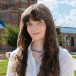 Photo of Jem standing in front of Tivoli building on Auraria Campus